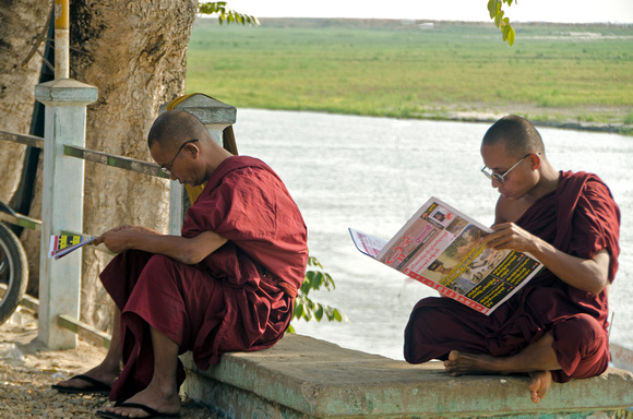 Monks reading on riverside