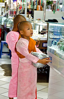 Young girl monk collecting alms in Bogyoke market