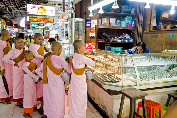 Female monks collecting alms in Bogyoke market