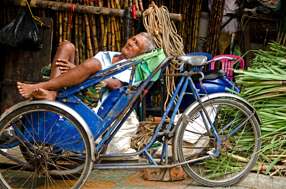 Rickshaw driver sleeping