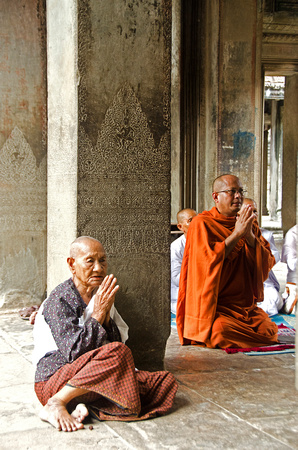 Old lady praying with Monk