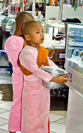 Young Novice monks collecting alms in Bogyoke market